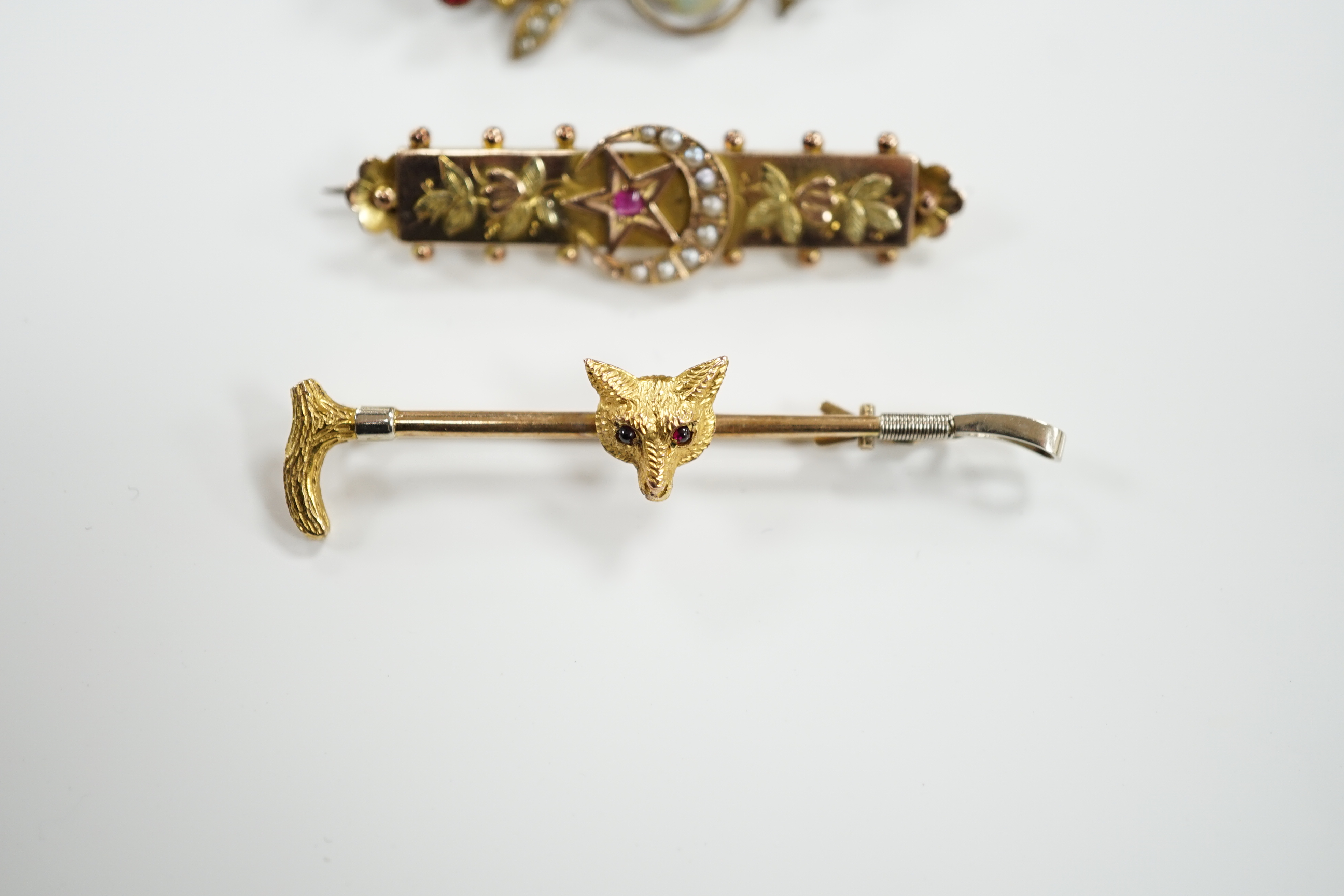 A 9ct and gem set fox head and riding crop bar brooch, 56mm, an Edwardian 9ct gold and gem set bar brooch and a rolled gold bar brooch.